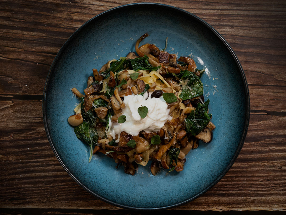 Homemade fettuccini with mushrooms and fresh spinach