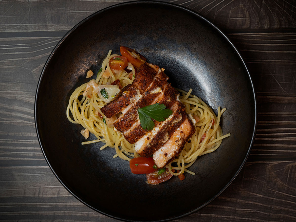 Spaghetti with seared salmon, chili, cherry tomatoes and fresh basil